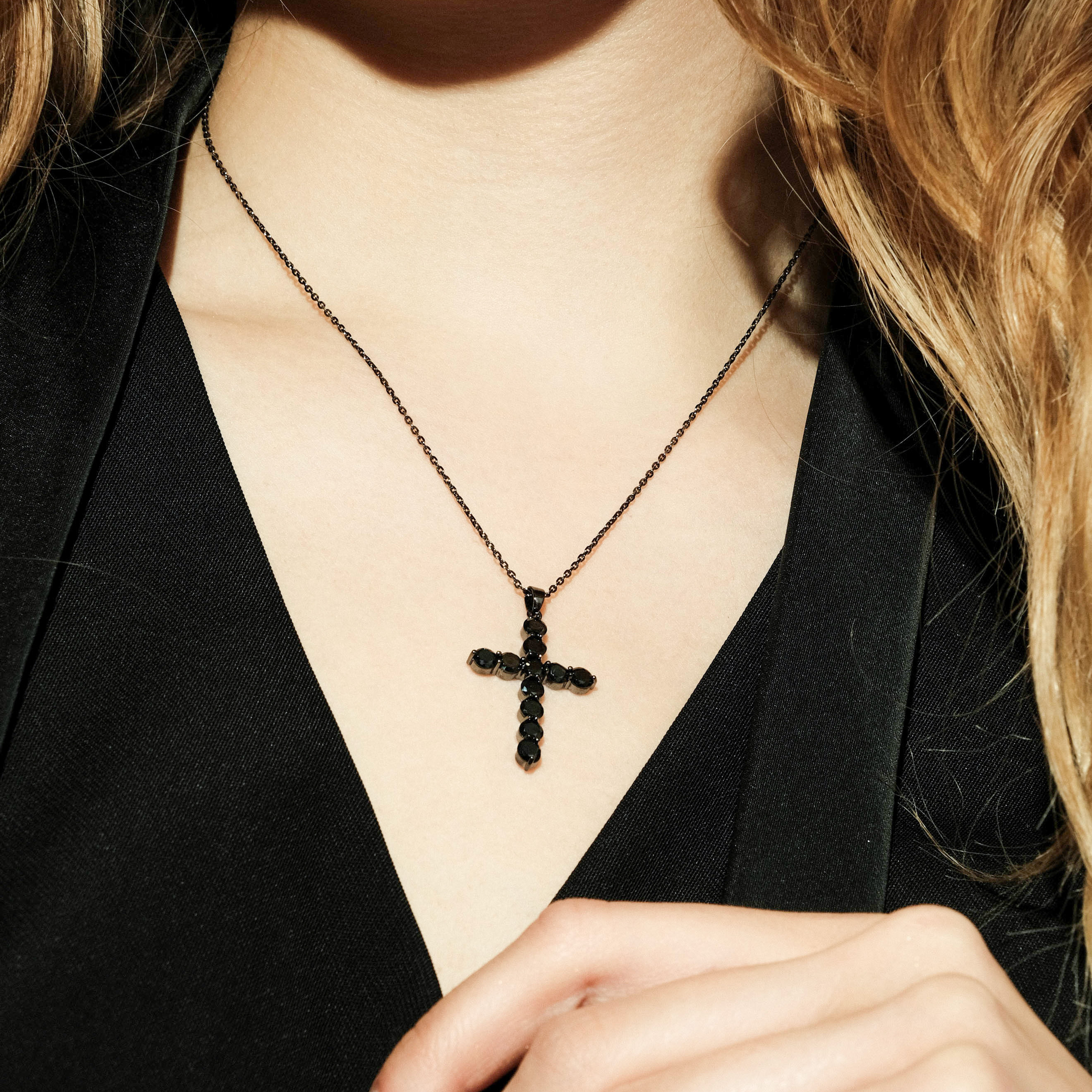 Black necklace with a cross pendant with black crystals