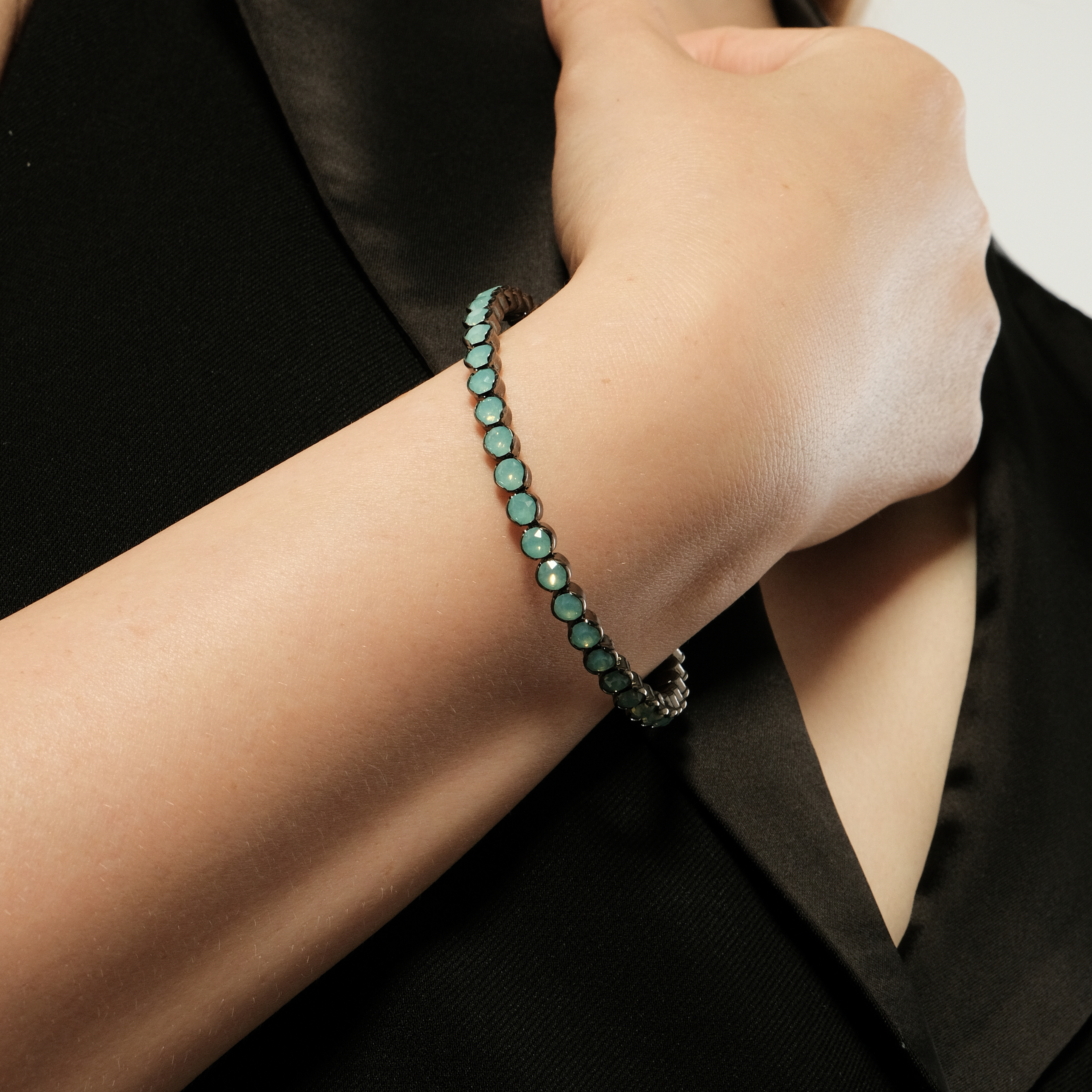 Silver open bracelet with green crystals