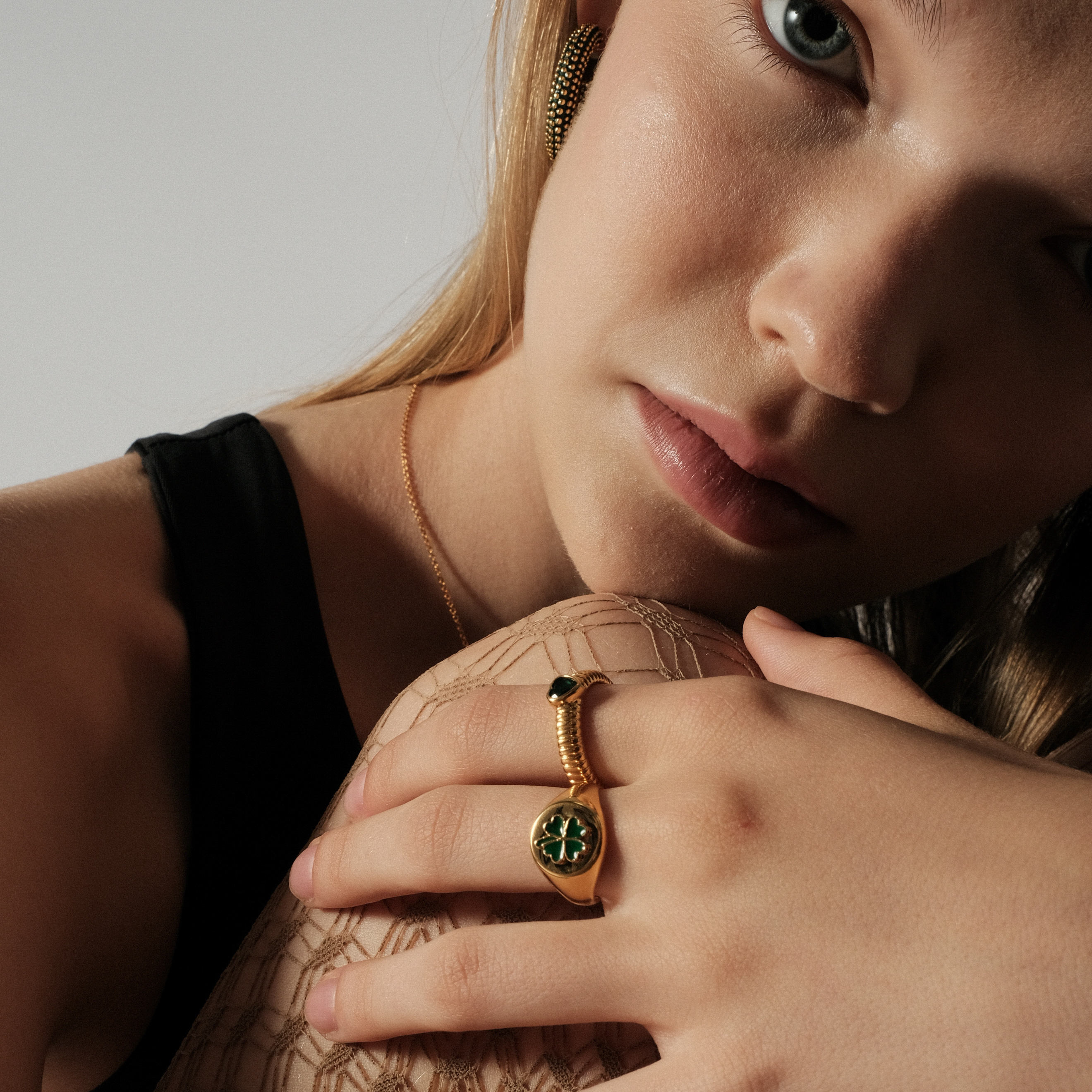 curly ring with a green heart