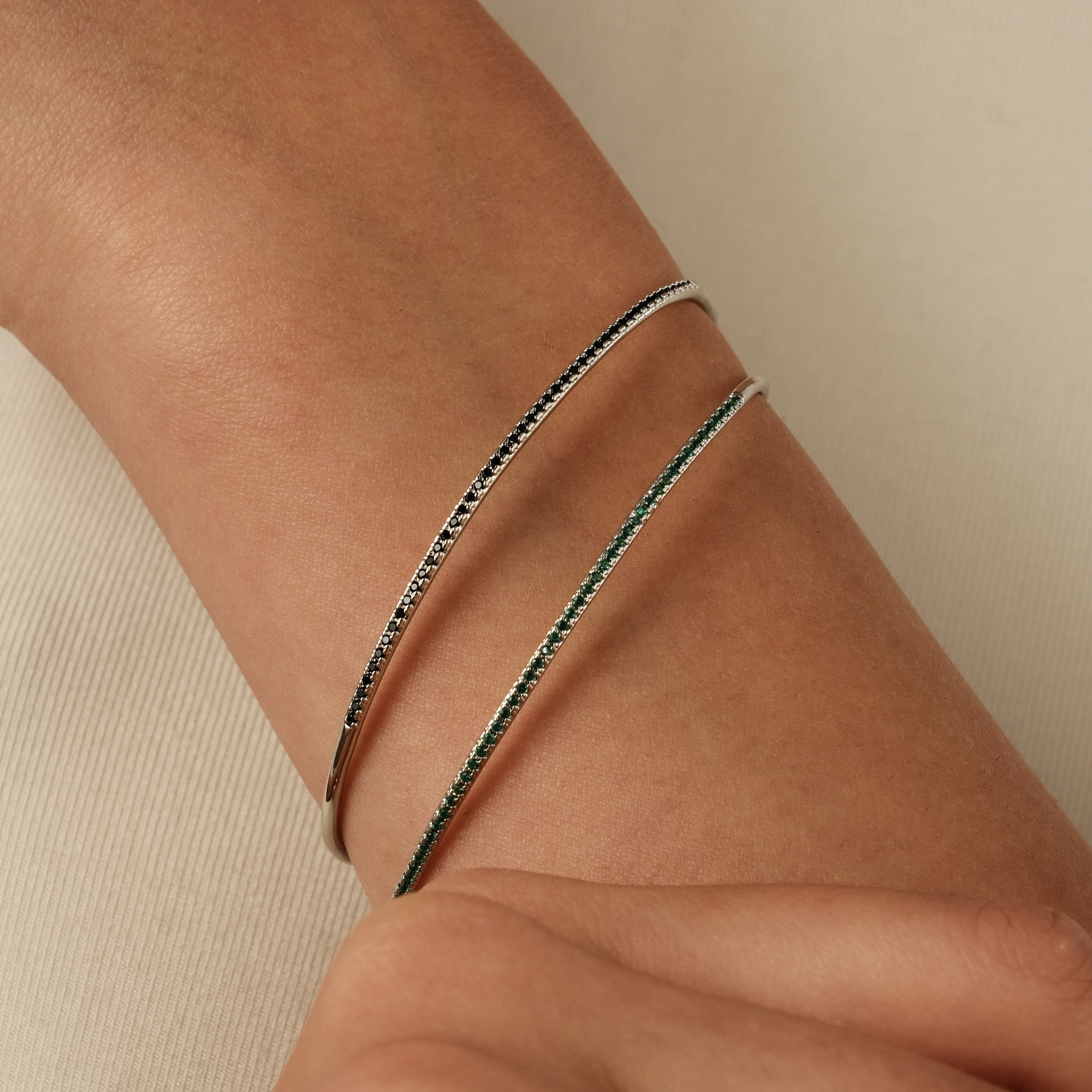 thin silver-tone bracelet with black crystals