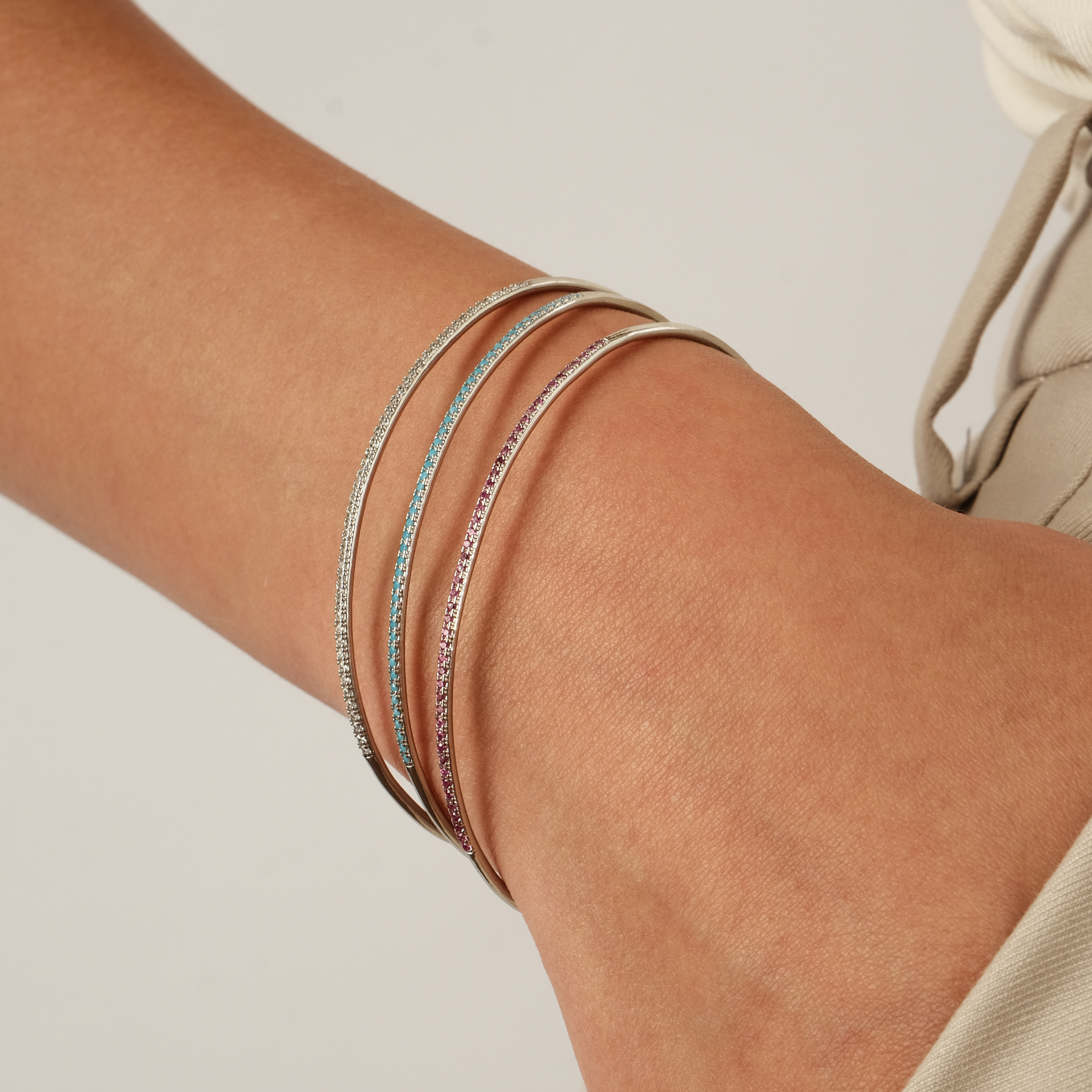 thin silver-tone bracelet with pink crystals