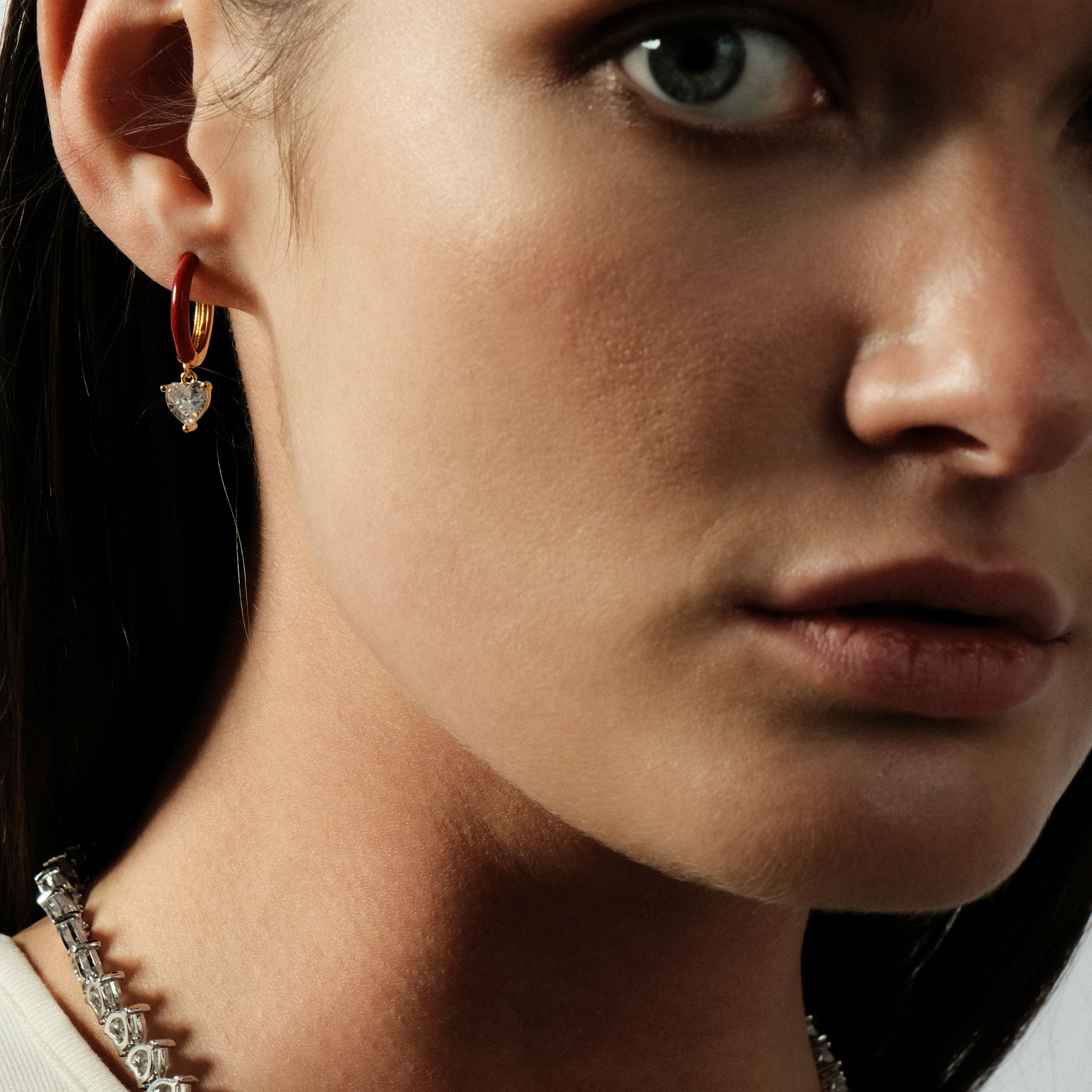gold-tone enamel earrings with a heart pendan