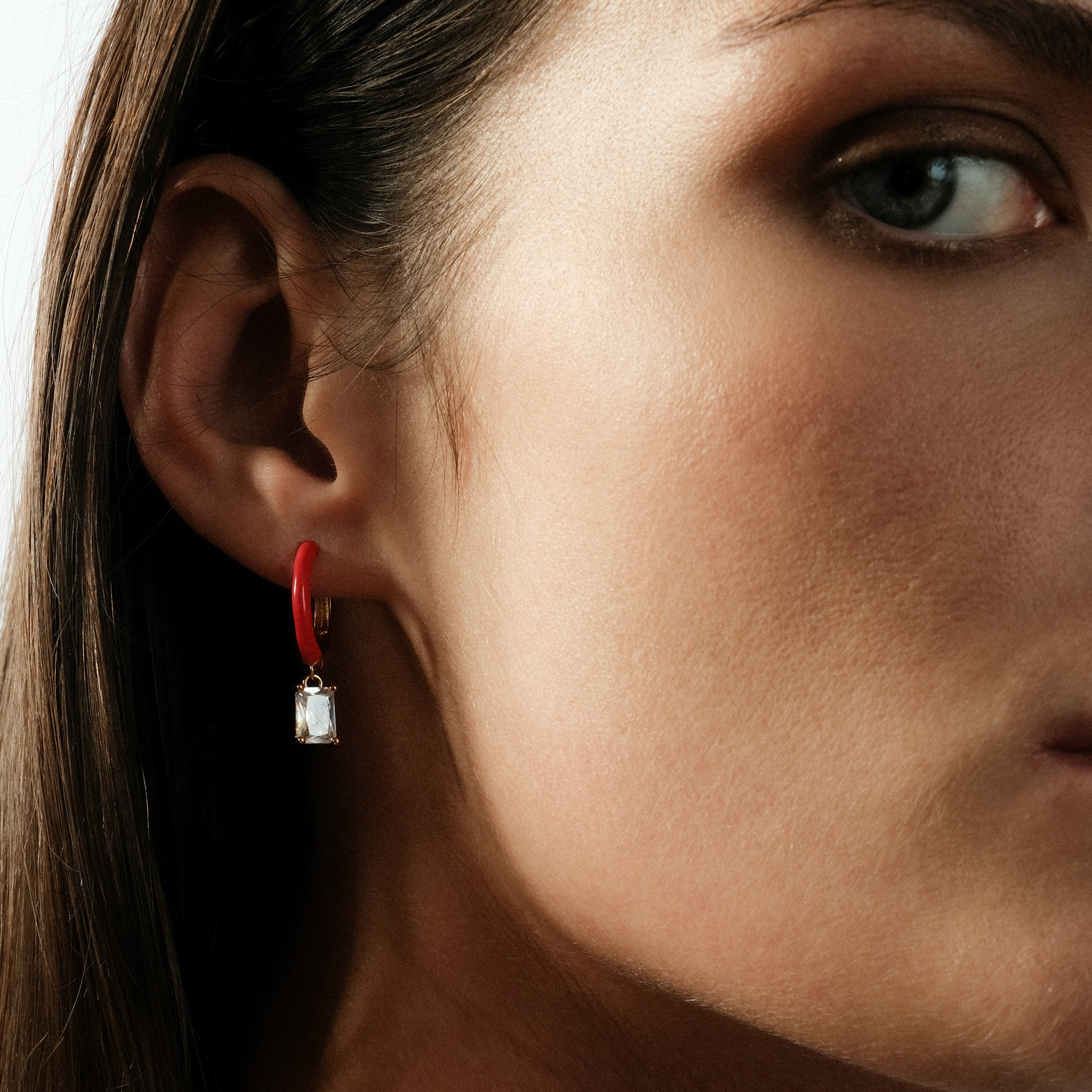 gold-tone enamel earrings with a baguette cut pendant