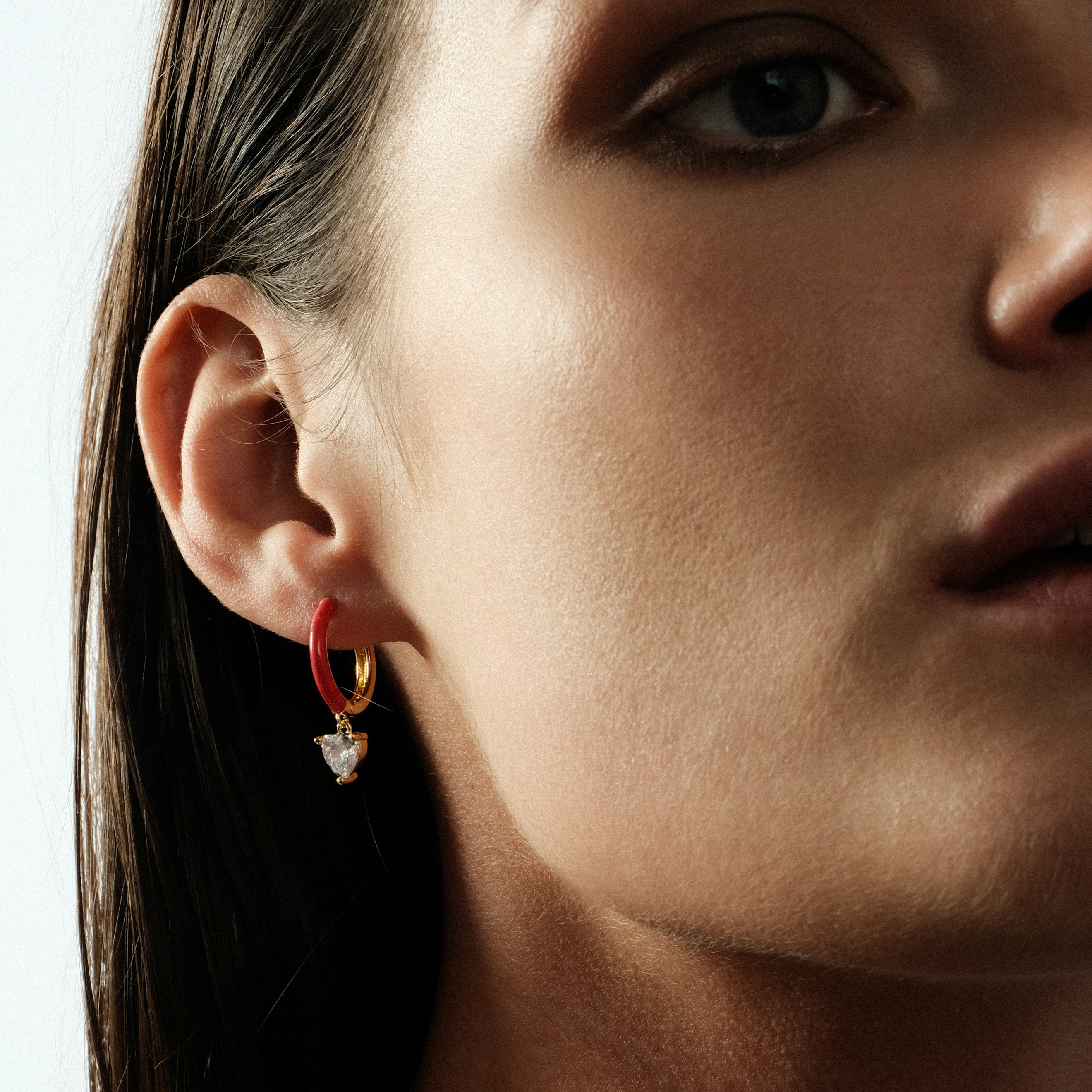 gold-tone enamel earrings with a heart pendant