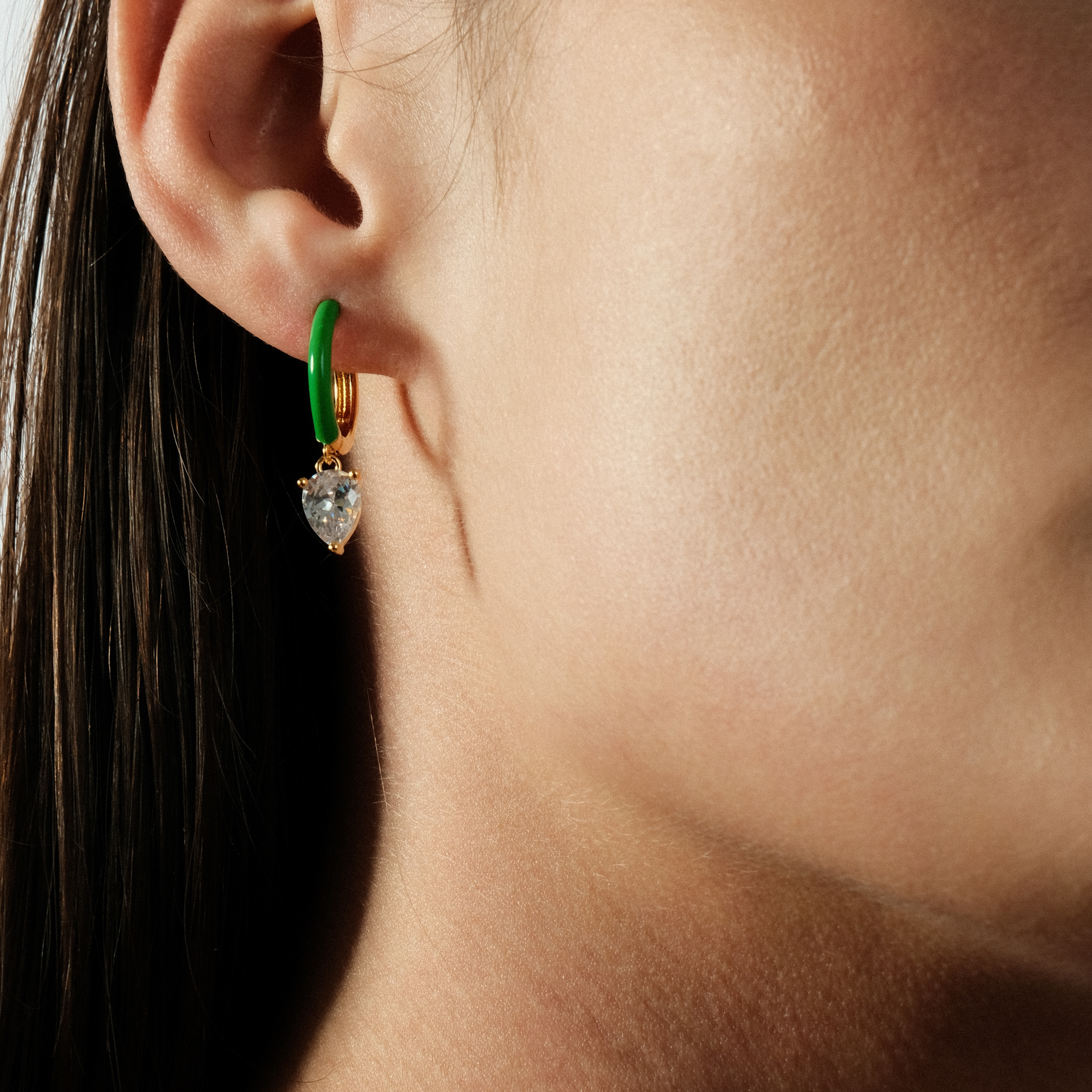gold-tone enamel earrings with an oval cut pendant