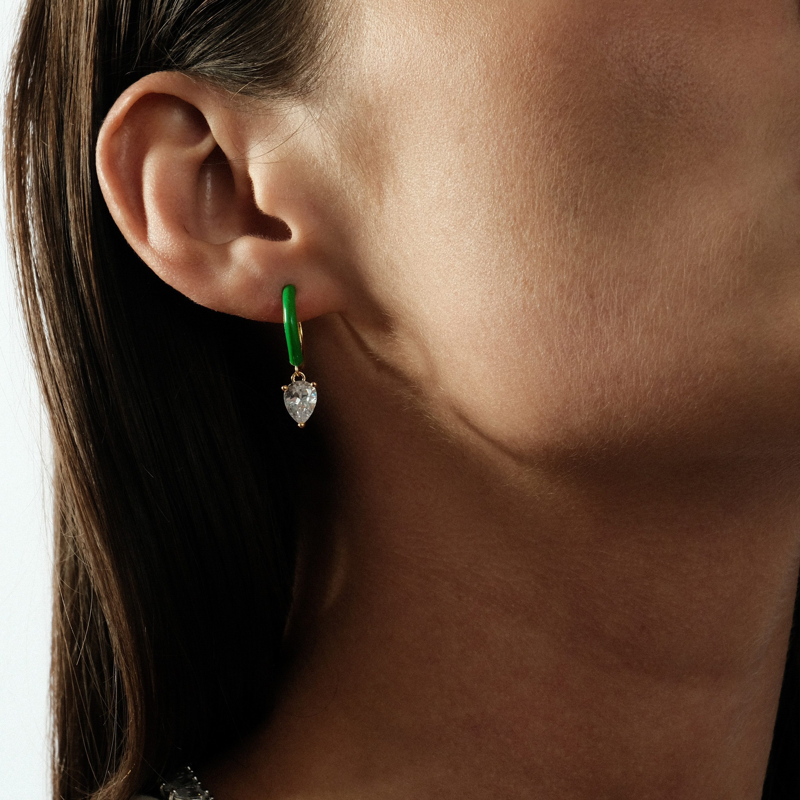 gold-tone enamel earrings with an oval cut pendant