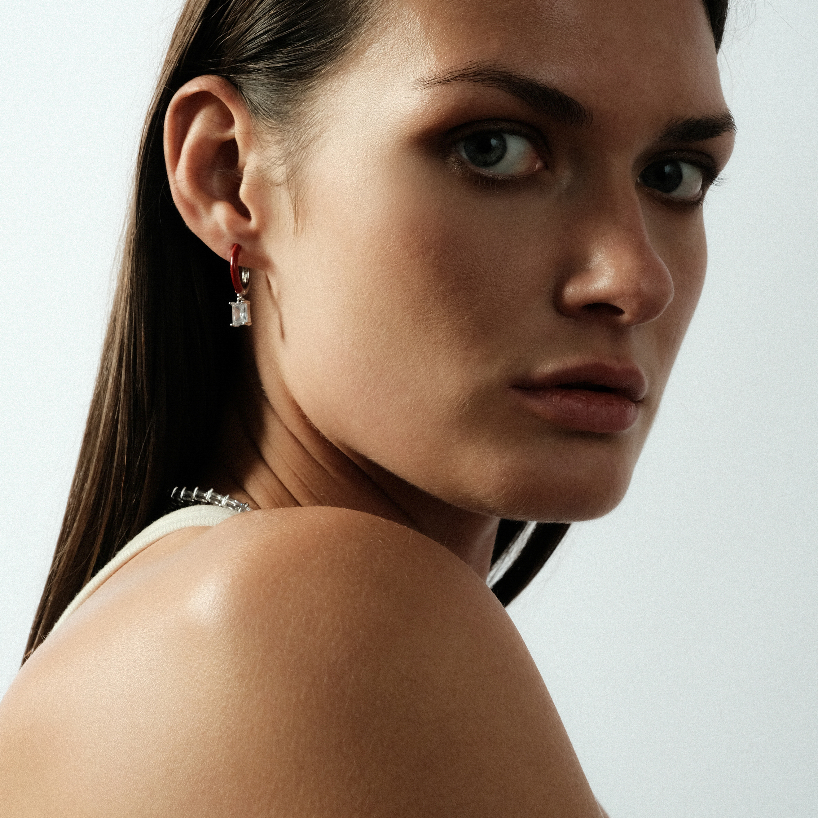 enamel earrings with a baguette cut pendant