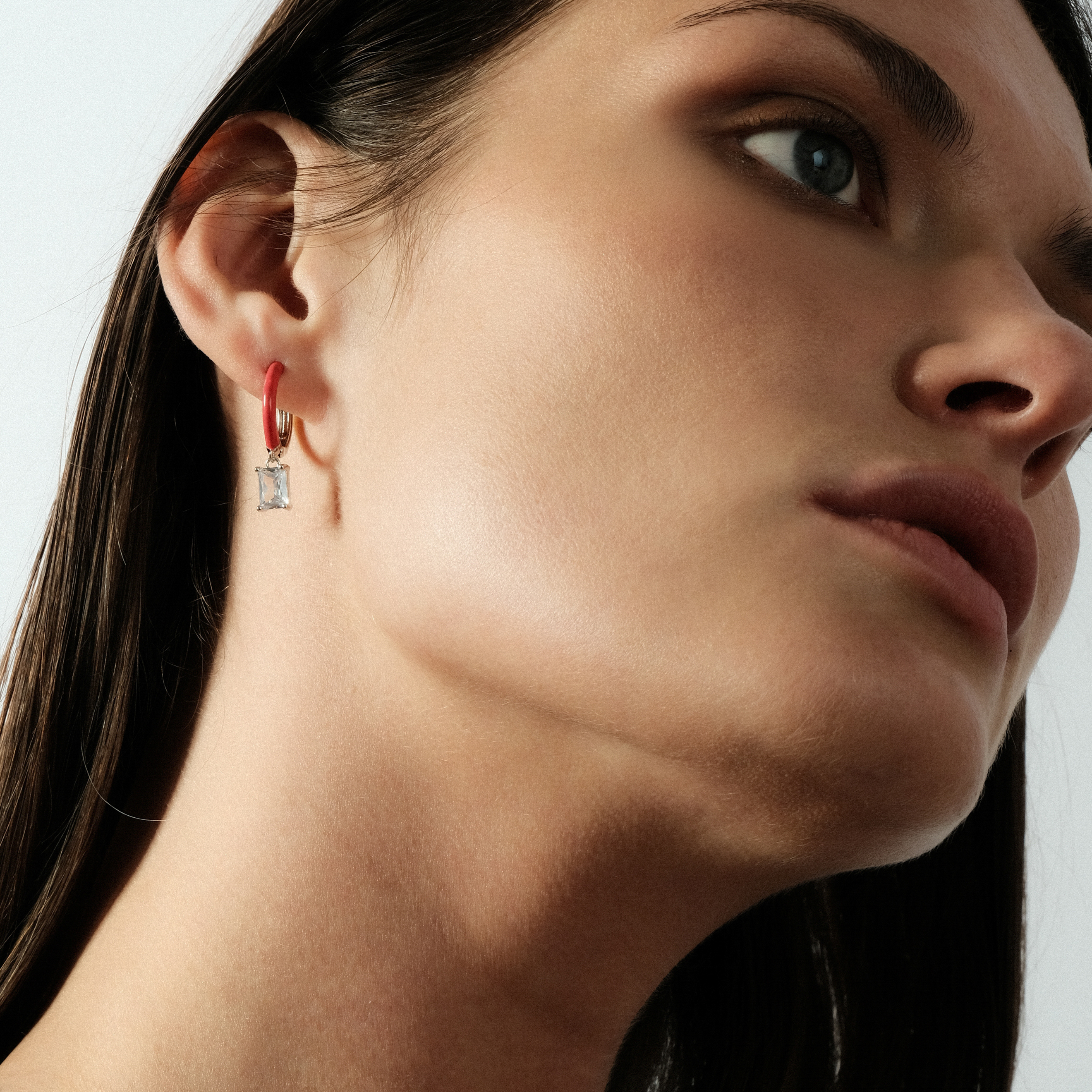earrings with red enamel with a baguette cut pendant