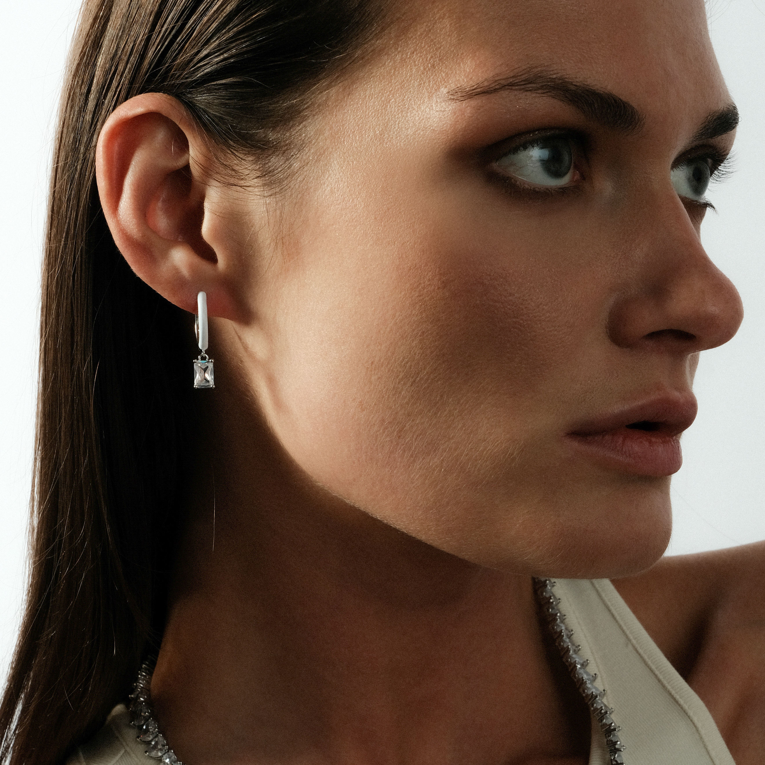 enamel earrings with a baguette cut pendant