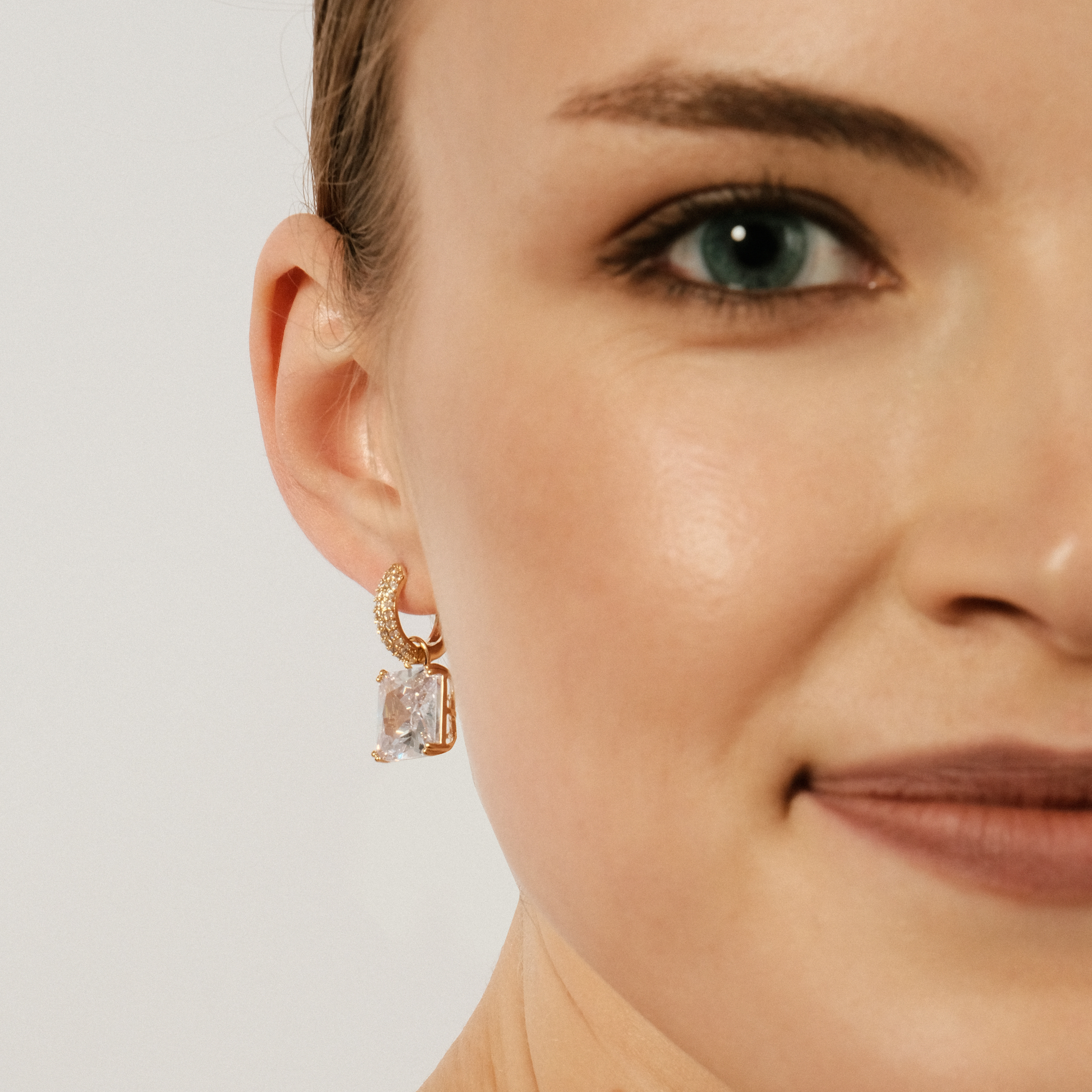 gold-tone earrings with a crystal