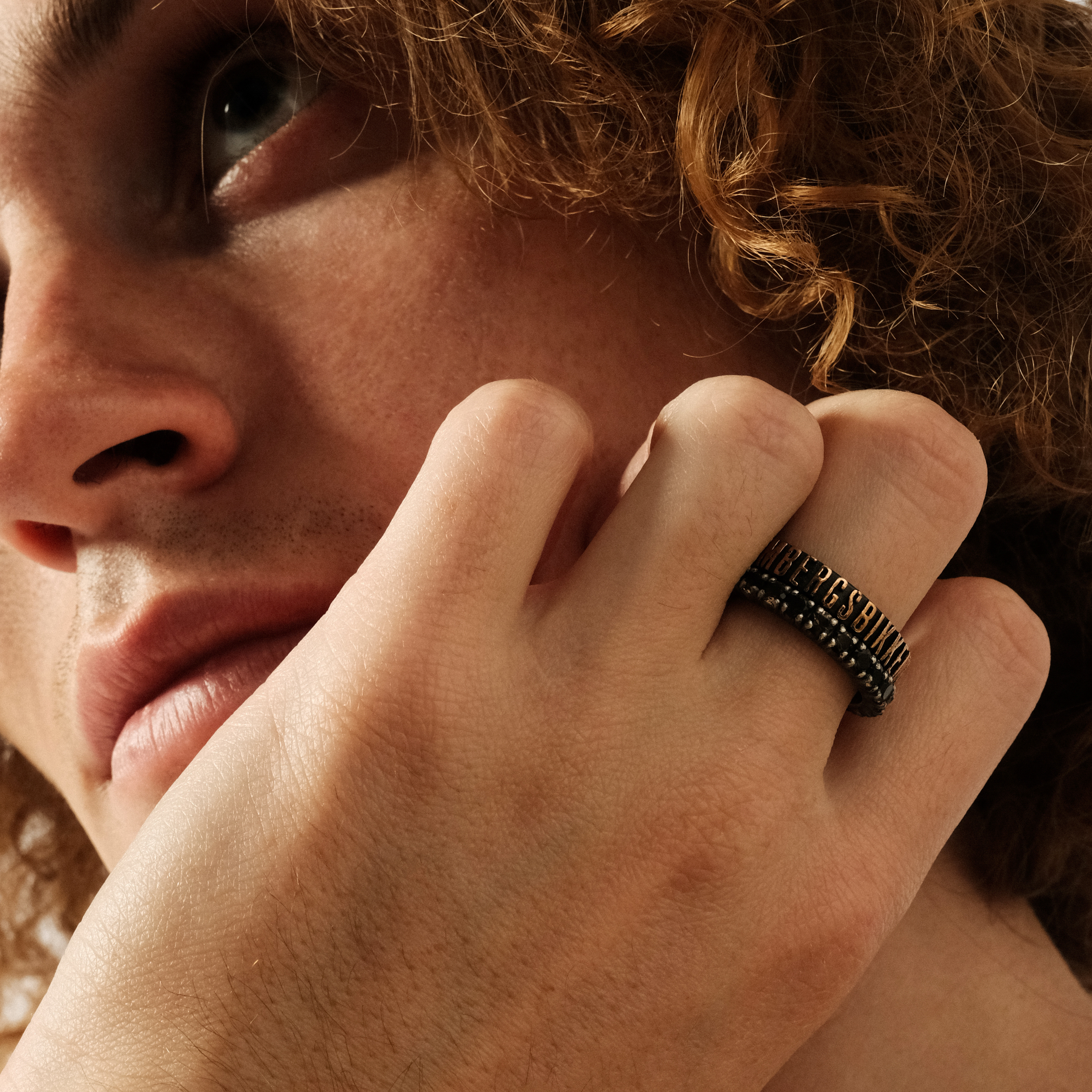 Black stainless steel ring with pink and gold letters