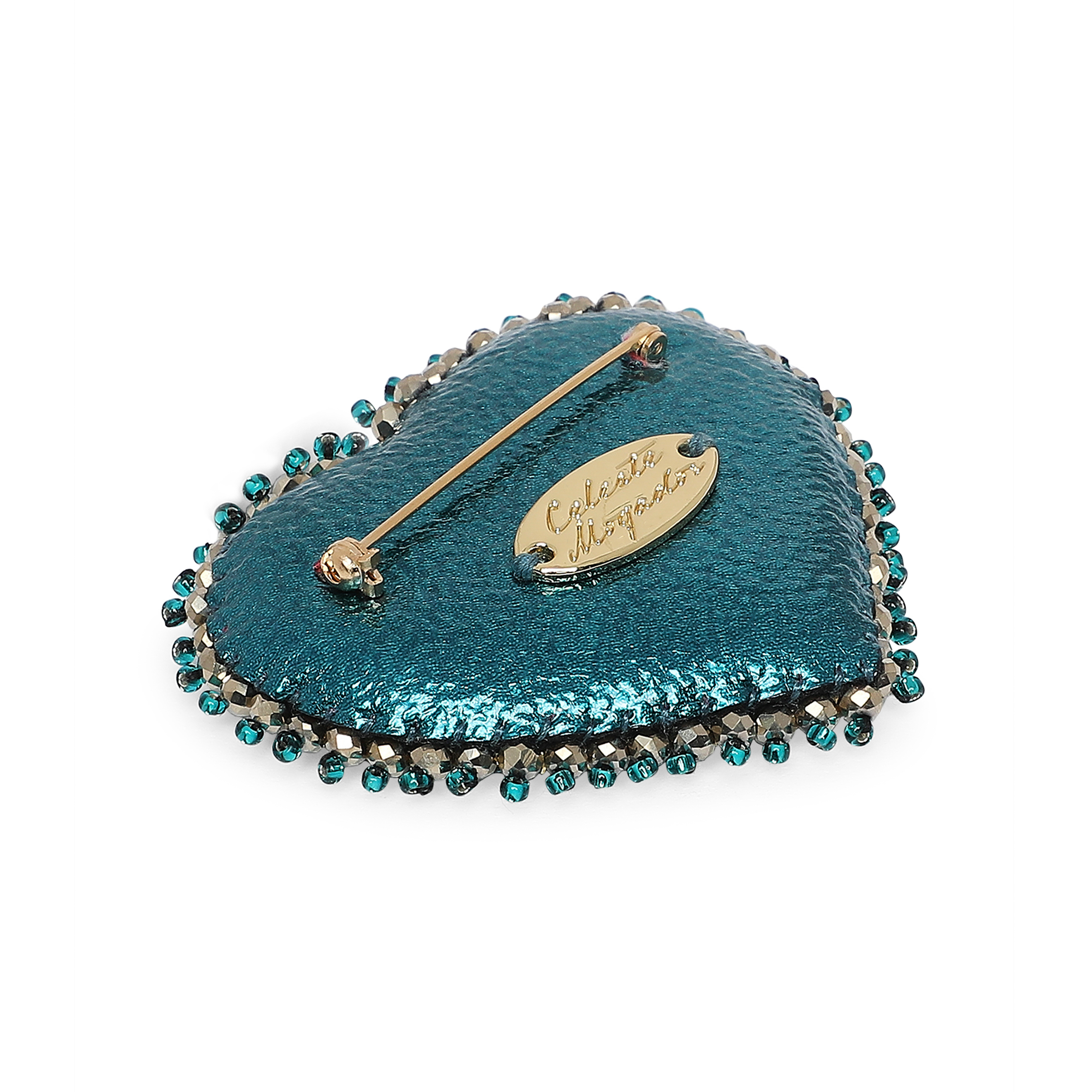 Heart brooch with an eye on a green background