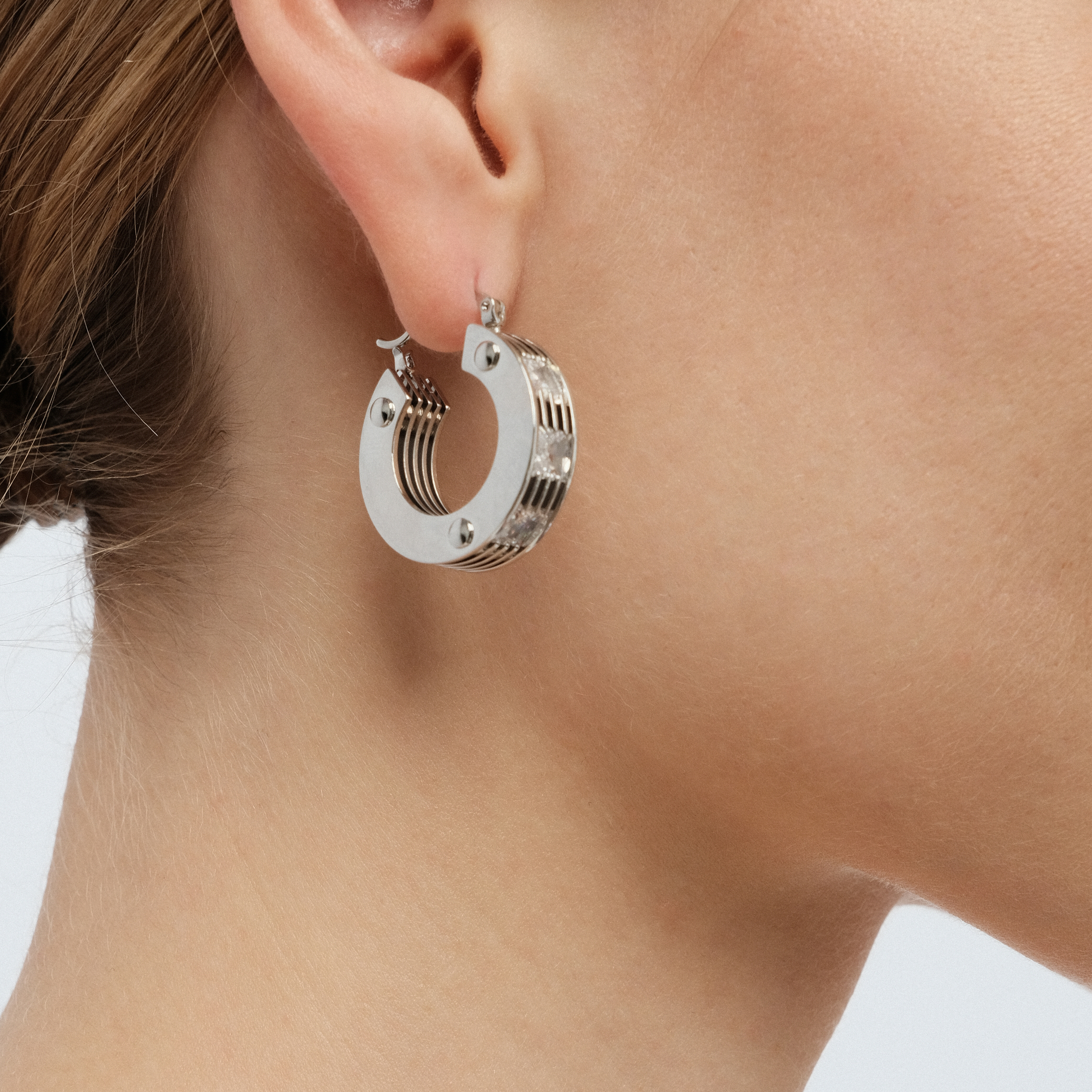 round earrings made of several plates with crystals