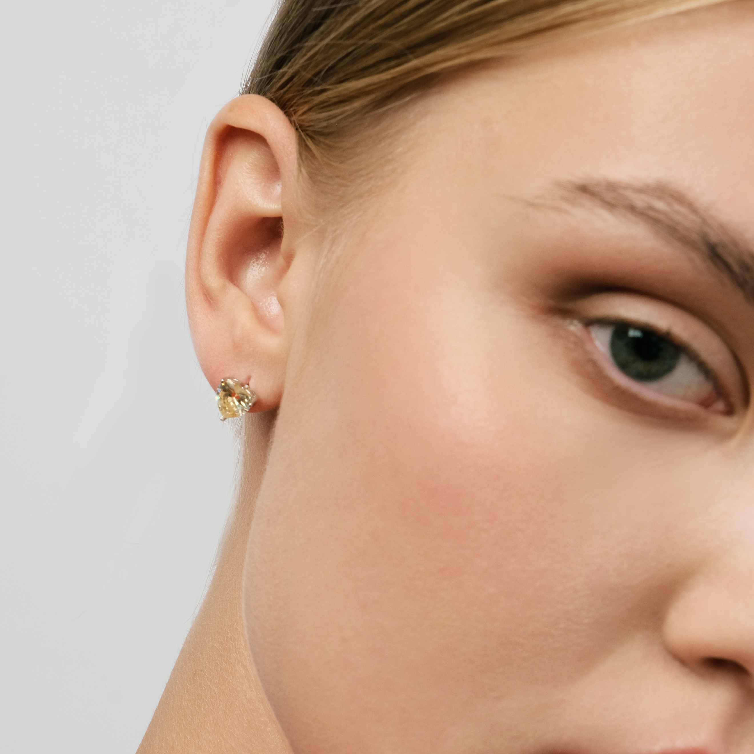 Silver earrings in the shape of a yellow heart
