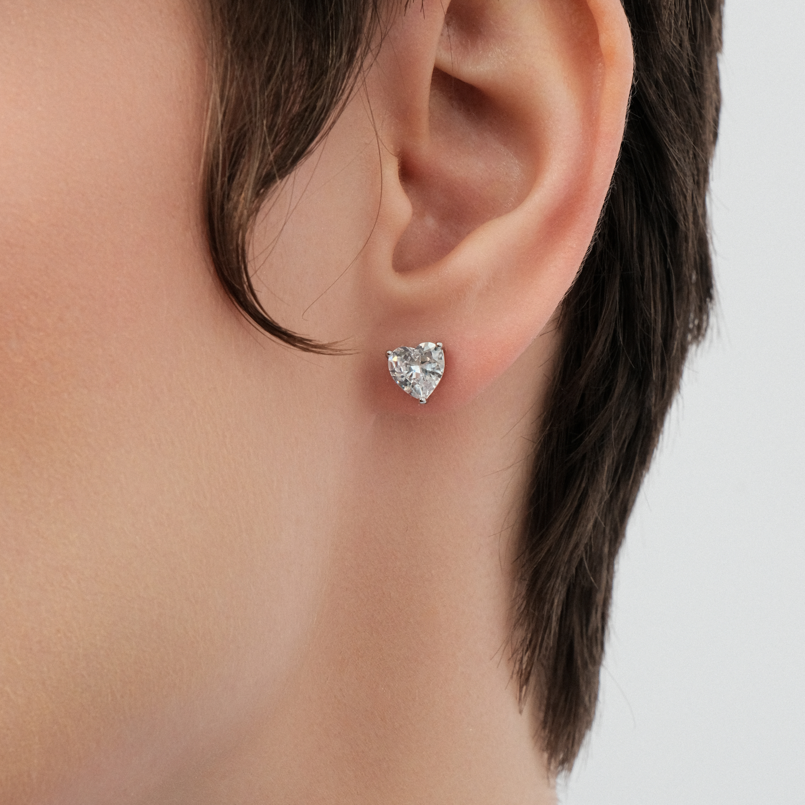 Silver earrings in the shape of a white heart