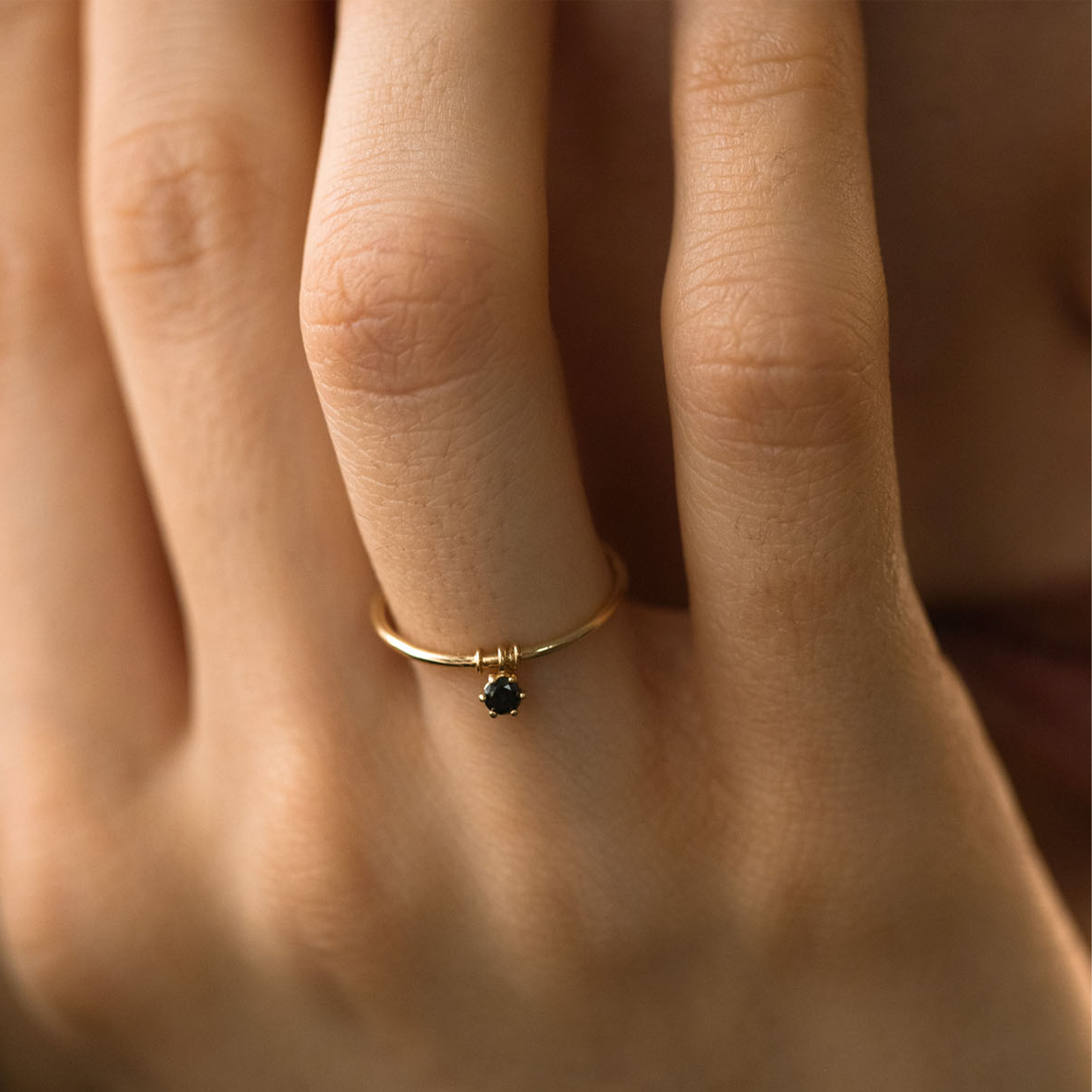 Black gold ring with movable element
