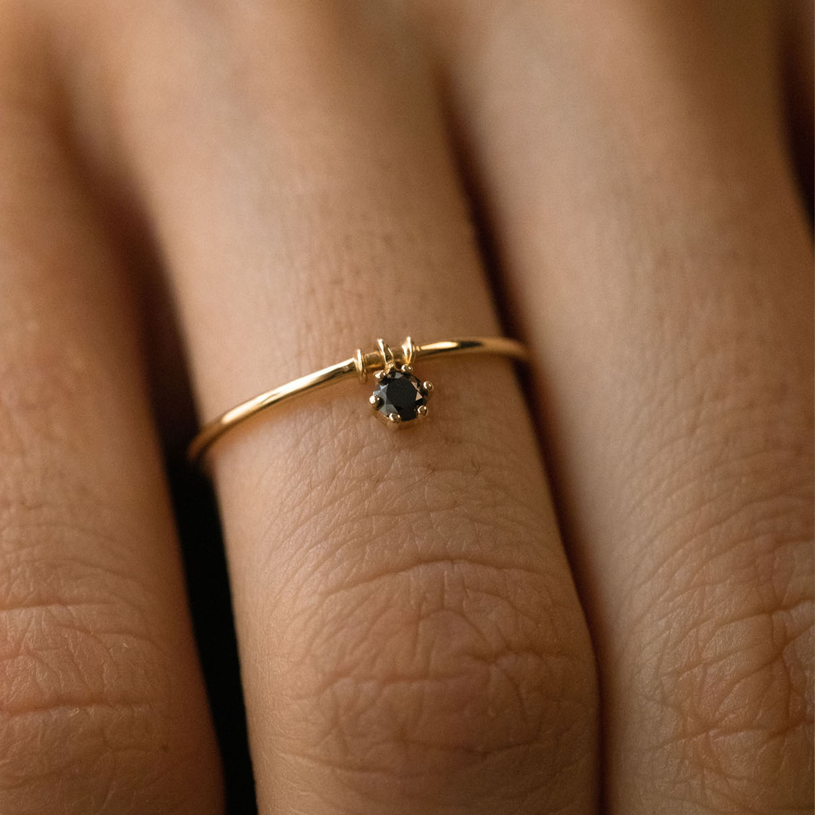 Black gold ring with movable element