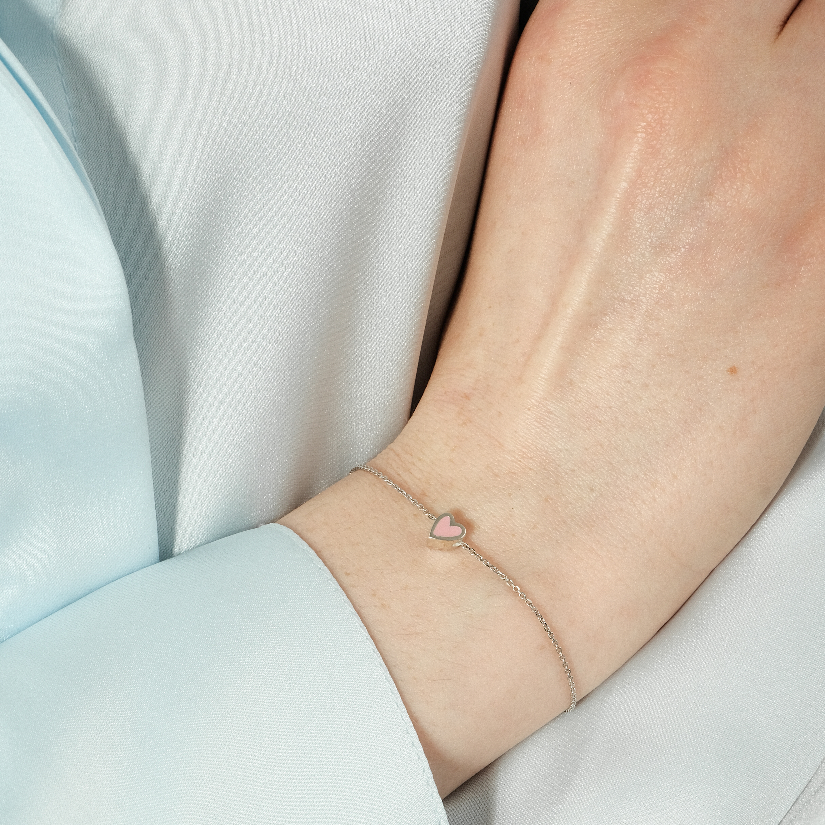 Silver bracelet with pink heart