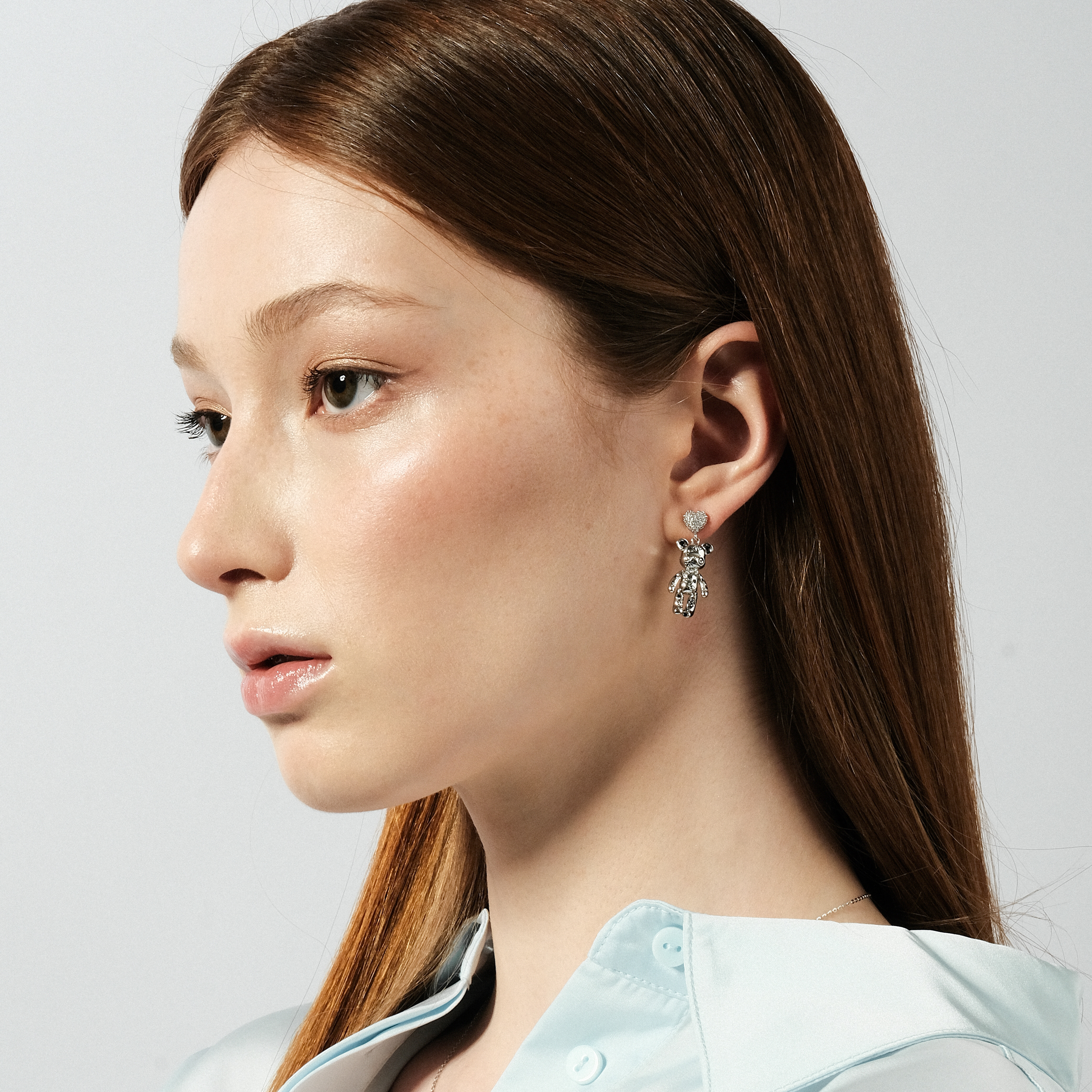 Silver teddy bear earrings with a heart