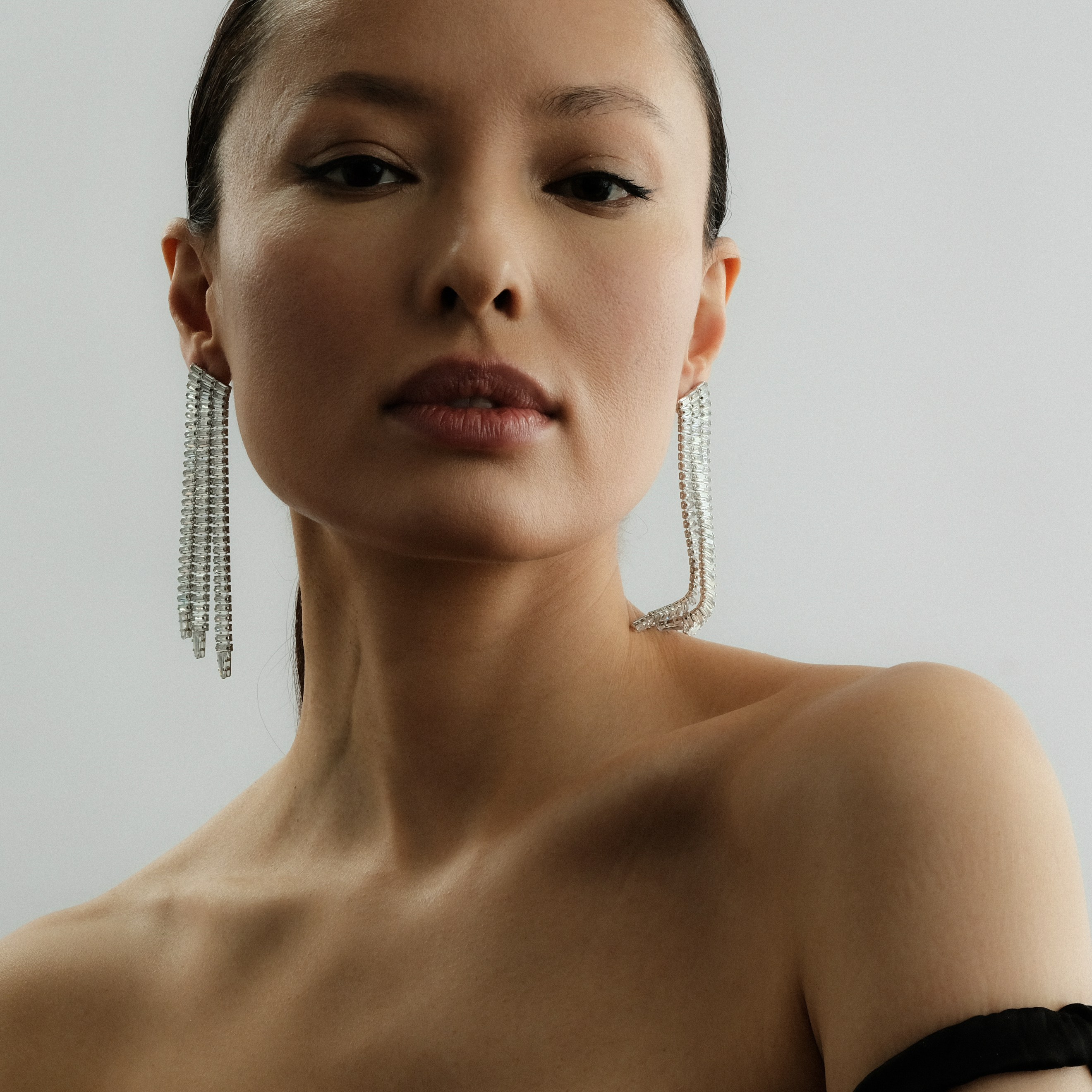Silver earrings with long crystal track pendants