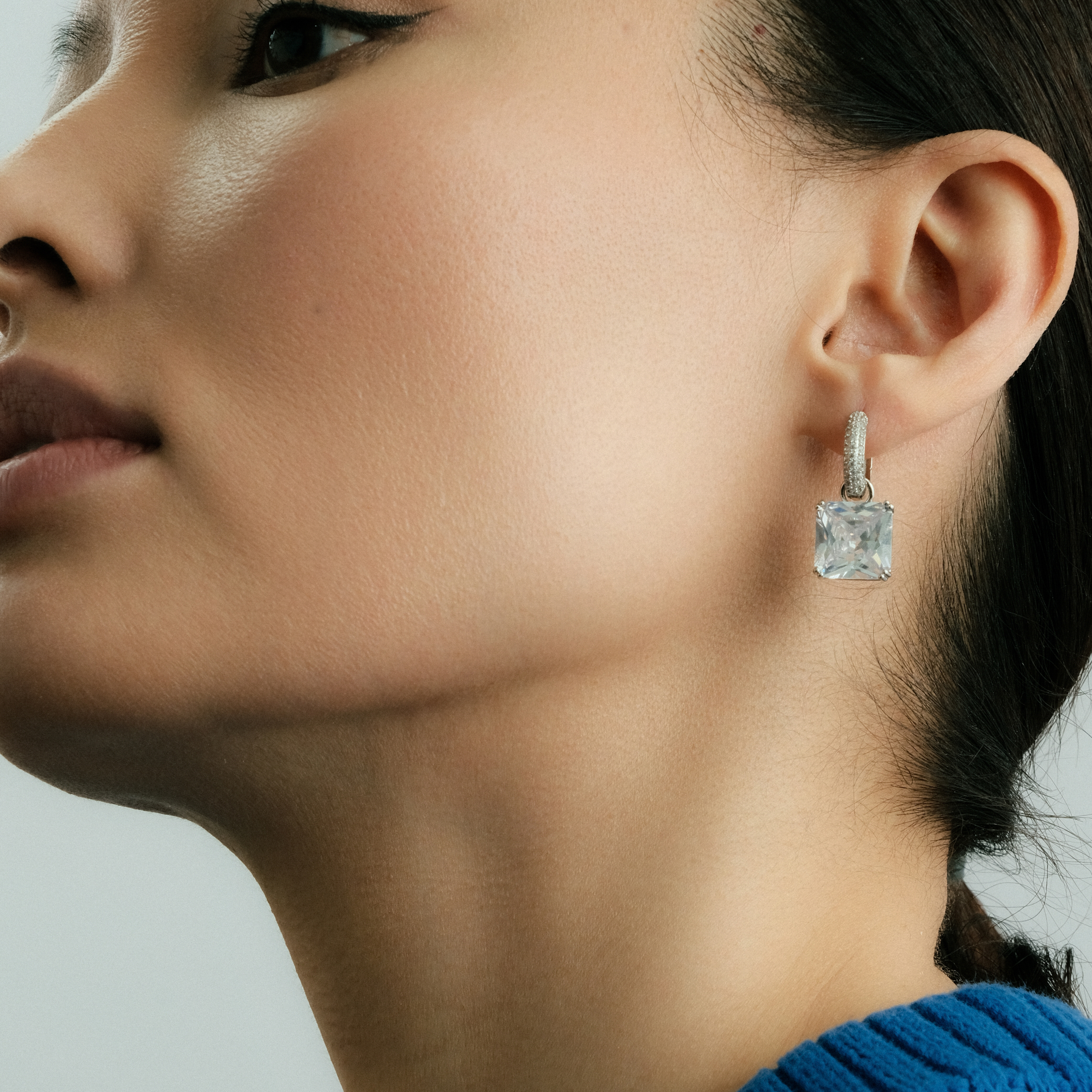 Silver earrings with a white stone
