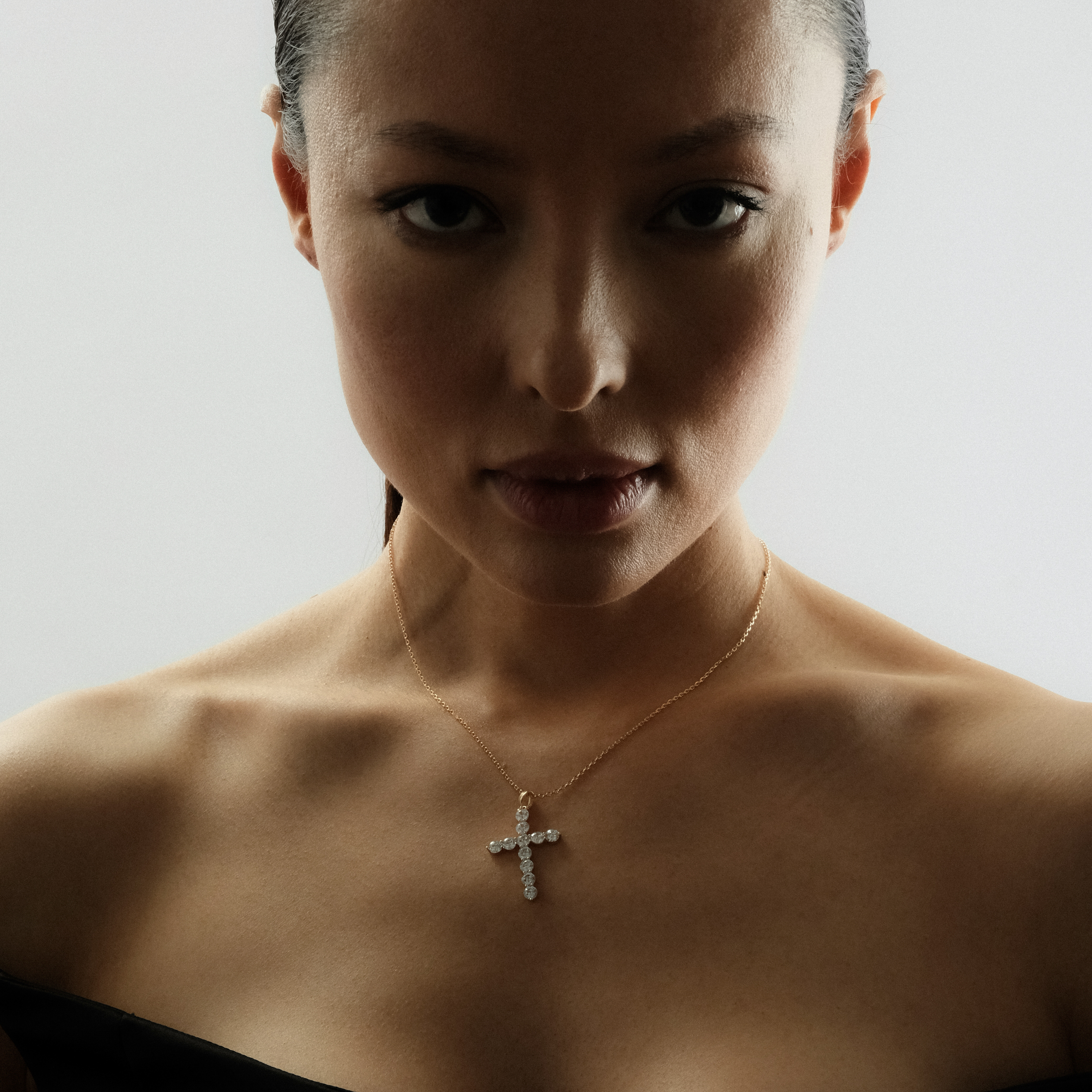 A large gold chain with a crystal cross